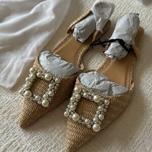 Raffia flats tagged Jimmy Choo for exposure